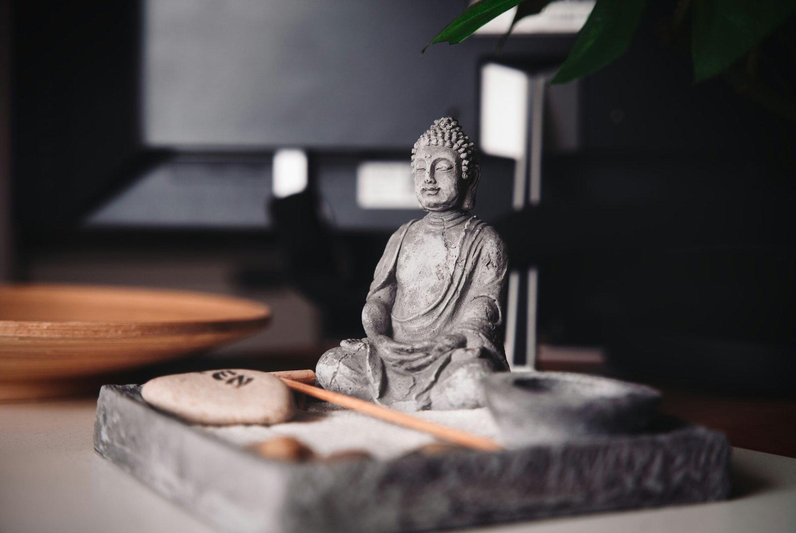 a buddha statue sitting on top of a table